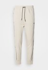 HADIKO - Tracksuit bottoms - light beige