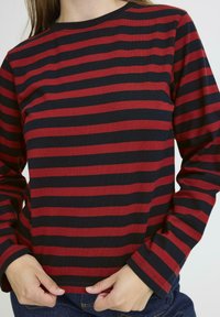 Long-sleeve shirt with red and navy horizontal stripes, crew neck, made of a soft fabric; features fitted sleeves and a straight hem.