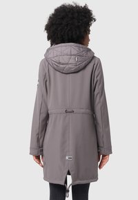Gray fitted coat with a quilted hood, drawstring waist, and sleek long sleeves. Features logo accent on the sleeve and a mid-length cut.