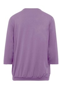 Lila Pulloveroberteil mit rundem Halsausschnitt und dreiviertel Ärmeln. Lockere Passform mit elastischem Saum. Glattes Baumwollmaterial.