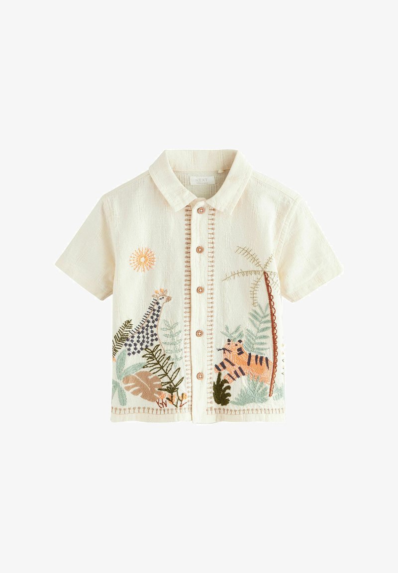 Chemise crème à manches courtes avec boutons et broderies de girafe, tigre, soleil, palmier et feuilles tropicales.