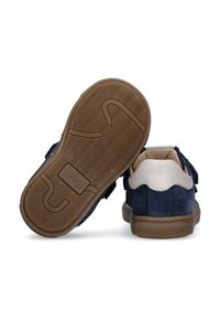 Scarpe di suede blu con dettagli bianchi e strap in velcro. Suola in gomma marrone con battistrada e motivo a onda. Design della punta arrotondata e interno imbottito.