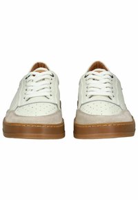 Sneakers bianchi in pelle con accenti in suede beige, design perforato sulla punta e suole in gomma marrone. Presentano lacci e cuciture bianchi.