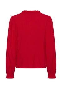 Blouse rouge à manches longues avec un col à volants, des manches froncées et un ourlet cintré. Confectionnée en tissu léger avec une texture lisse.