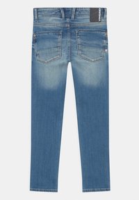 Niebieskie dżinsy z denimu, z półwysokim stanem, prostym krojem nogawek i dwoma tylnymi kieszeniami. Jasne przetarcia na udach. Metka marki na pasku.