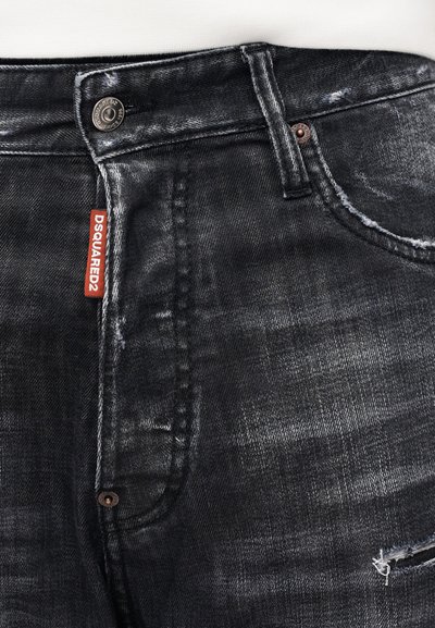 Black denim jeans with a faded texture, distressed details, and a red tag labeled "DSQUARED2" near the waist. Metal button and stitching visible.