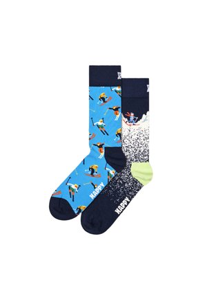 Blue and navy socks featuring colorful skiing figures, textured patterns, and logo detail. One sock has a green accent and splatter design.