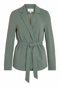 Grön skräddarsydd kavaj i mjukt tyg med slagkrage och långa ärmar. Har en bälte i midjan och platta framfickor.