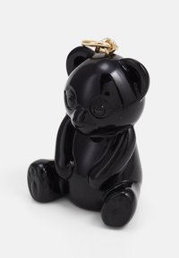 Black resin panda-shaped figurine with smooth texture, round ears, and golden keyring loop attached to the head.