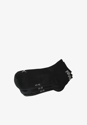 Schwarze Sportsohlen, Größe 43-46, mit einem gerippten Bündchen und einem weißen Logo an der Außenseite. Glatte Textur mit eng anliegendem Sitz.