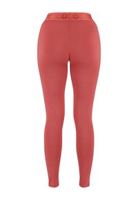Rode leggings met een aansluitend ontwerp, gemaakt van rekbaar materiaal. De hoge tailleband heeft een textuurpatroon langs de bovenrand.