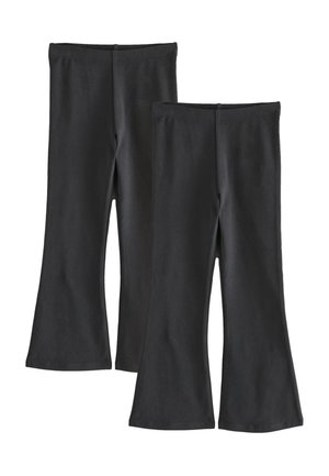 Kaks paari musta lõhkuvate pükste elastsete vöökohaga, laotud valgele taustale.