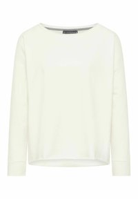 Chemise manches longues beige clair avec un col rond et une coupe décontractée. Tissu doux avec une texture lisse, comportant une petite étiquette de logo à l'intérieur.