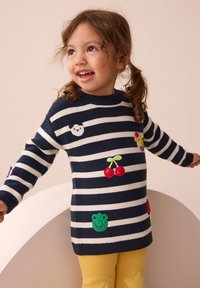 Navy and white striped knit sweater with colorful embroidered accents of a panda, cherries, and a frog. Paired with yellow star-patterned leggings.