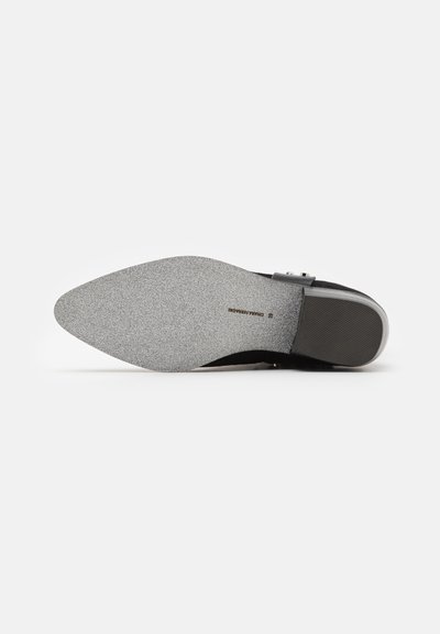 Black shoe sole with a smooth, grey textured finish. Features a sleek, pointed shape and a subtle brand logo embossed on the insole.