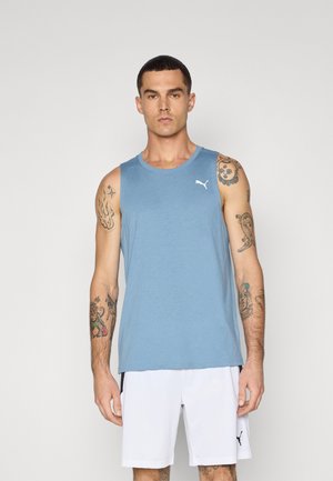 Blue cotton tank top with a round neckline and a white logo on the chest, paired with white shorts. Suitable for athletic wear.