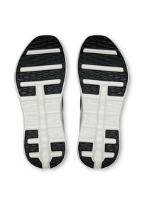 Soli di scarpe sportive in bianco e nero con un motivo testurizzato e scanalature per la presa. Include accenti in gomma e un design leggero.