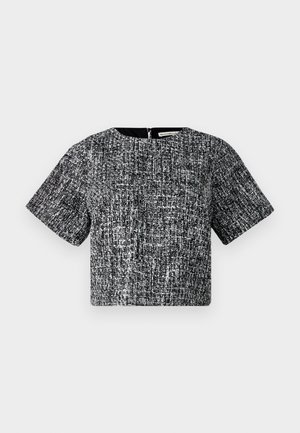 Top corto a maniche corte in tessuto texturizzato bianco e nero. Presenta un collo a giro e una zip invisibile sul retro.