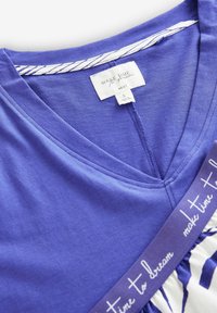 Purple short-sleeve top featuring a v-neck, white striped neckline, and a decorative band with "make time to dream" text at the hem.