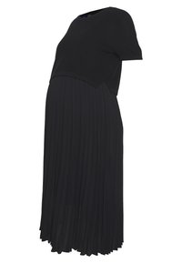 Robe de maternité noire à manches courtes et jupe plissée, conçue pour le confort et le style pendant la grossesse.