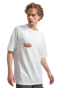 Witte katoenen t-shirt met een kleurraf afbeelding van een tas en fruit op de linker borst. Loose fit met een ronde hals.