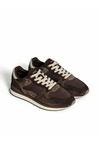 Brown and beige casual sneakers with suede and fabric panels, white laces, and cushioned soles angled on a white background.