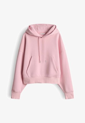Felpa corta rosa con tasca frontale, cappuccio con coulisse e maniche larghe. Realizzata in tessuto morbido con polsini e orlo a coste.