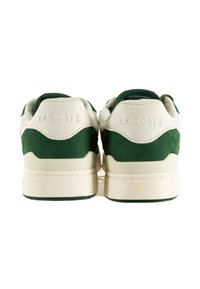 Sneaker verdi e crema realizzati in materiali scamosciati e in pelle, con un tallone testurizzato, logo impresso e una suola in gomma spessa.