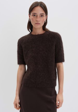 Brown mohair blend short-sleeve sweater with a textured, fluffy finish and a round neckline, paired with a solid brown fitted skirt.