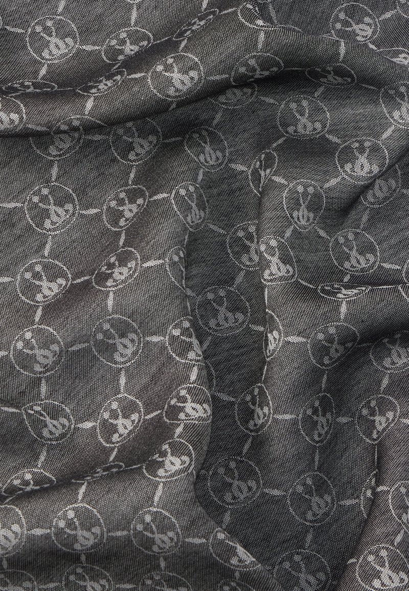 Schwarzer und grauer Stoff mit einer strukturierten Webart, der ein sich wiederholendes kreisförmiges Muster und subtile Akzente in Hellgrau aufweist.