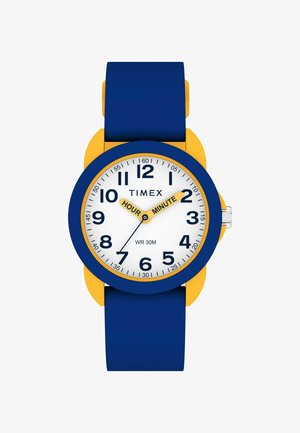 Reloj Timex con una correa de silicona azul, acentos amarillos y un dial blanco. Grandes marcadores horarias negros; resistencia al agua clasificada hasta 30 metros.