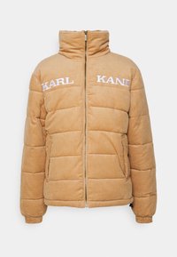 Giubbotto puffer in cotone a costine di colore sabbia, con colletto alto, zip frontale, polsini elasticizzati, tasche laterali e scritta "KARL KANI" ricamata sul petto.