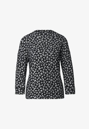 Top de estampado de leopardo en blanco y negro con mangas largas, cuello redondo y un corte holgado. Material de punto suave con acabado texturizado.