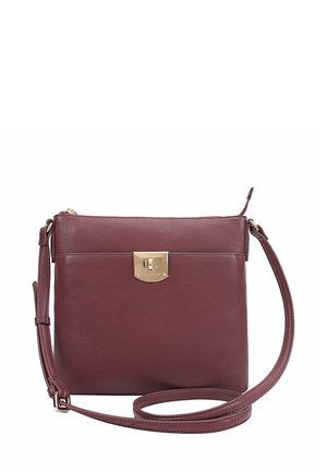 Burgundy leather crossbody bag with a gold-tone clasp, flat design, adjustable strap, and smooth texture. Simple and functional.