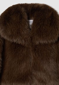 Giacca di pelliccia sintetica marrone con colletto ampio, caratterizzata da una superficie morbida e testurizzata. Etichetta visibile all'interno che indica la taglia 'S'.