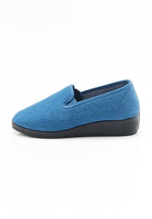 Blue slip-on shoe made of textured fabric with a black rubber sole, featuring elastic side panels for flexibility and comfort.