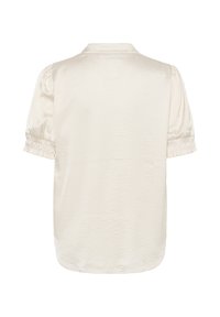 Blouse à manches courtes couleur crème avec manches bouffantes et poignets élastiques, avec un petit col et une texture de tissu lisse, vue de dos.