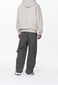 Pegador Jersey con capucha - sand