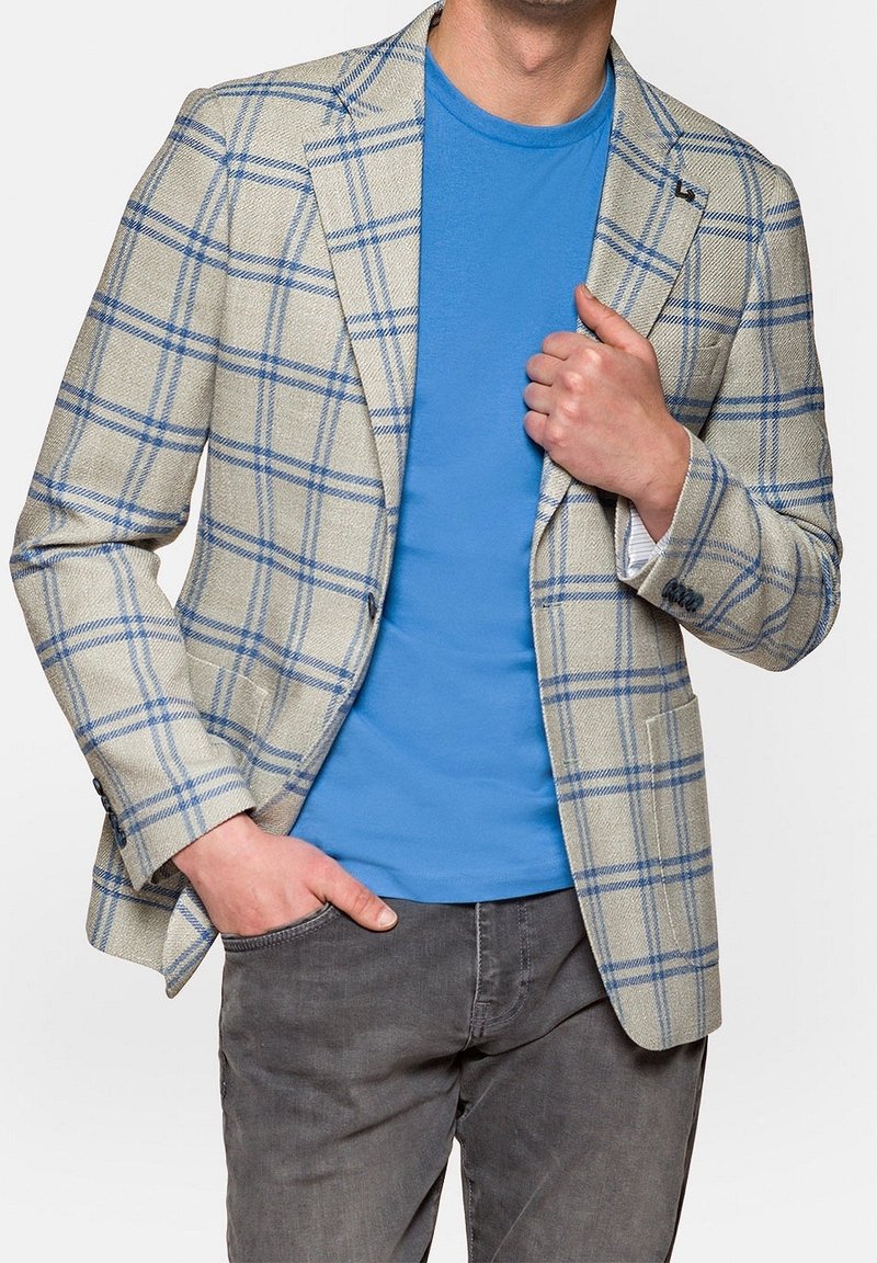 Light beige blazer with a blue check pattern, featuring a single-breasted design, notch lapels, and two front pockets, worn over a blue t-shirt.