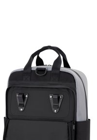 Black and gray backpack featuring durable fabric, dual top handles, zipper closure, and metal hardware accents. Rectangular shape with pockets.
