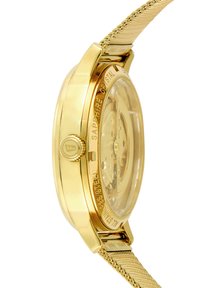 Orologio dorato con cassa trasparente, cinturino a maglia e cristallo di zaffiro. Presenta un movimento visibile e testo inciso sul retro.