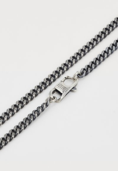 Silvermetallkedja med sammanlänkade ovala länkar, med en texturerad yta och en fjäderklämma för säker förslutning.