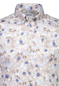 Blomstret skjorte med knapper, lys beige bakgrunn, blå og brune blomsterprint og klassisk krage. Knappene er hvite.