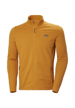 Chaqueta mostaza con cremallera completa, cuello alto, dos bolsillos laterales con cremallera y logo "HH" gris en el pecho izquierdo.