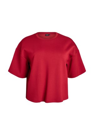 Crvena kratkoslezna oversized majica napravljena od mekog materijala, sa okruglim izrezom i spuštenim ramenskim šavovima za opušteni izgled.