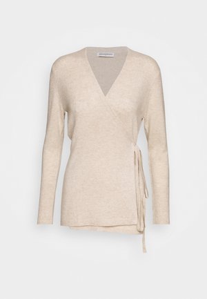 Beige long-sleeve wrap sweater with V-neck and side tie closure, made from soft knit fabric.