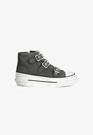 High-top sneaker in dark gray suede with silver buckles, metallic toe cap, and textured white platform sole featuring a decorative pattern.