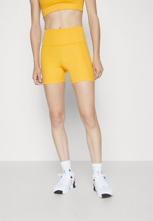 Girlfriend Collective RUN SHORTS - Κολάν - golden glow