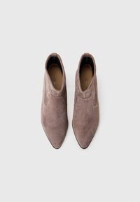 Gray suede ankle boots with a pointed toe, smooth texture, and low cut design. Inner lining appears tan with branding visible inside.
