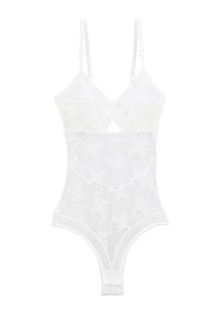 Bodysuit en dentelle blanche avec des bretelles réglables, un motif floral et des bords festonnés. Comprend un détail découpé au centre et une texture lisse.